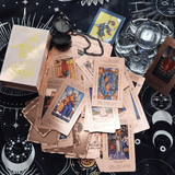 The Witch's Cauldron Rose Gold Tarot Card Set includes a guide booklet and is suitable for beginners. It features information on chakras, planets, zodiac signs, elements, and affirmations.